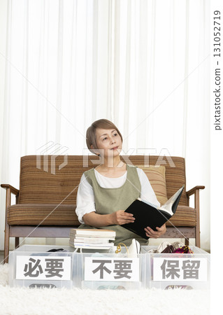 Senior woman decluttering in the living room 131052719