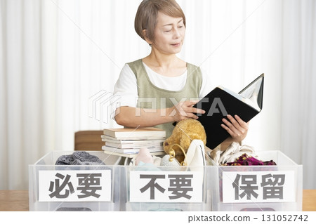 Senior woman decluttering in the living room 131052742