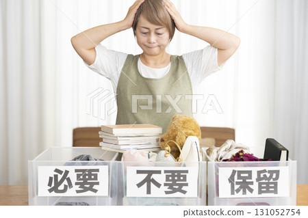 Senior woman decluttering in the living room Senior woman decluttering in the living room 131052754