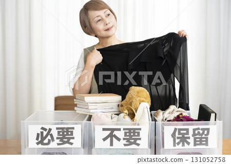 Senior woman decluttering in the living room Senior woman decluttering in the living room 131052758