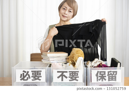 Senior woman decluttering in the living room Senior woman decluttering in the living room 131052759