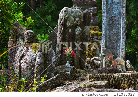 Stone pagodas, stone Buddha statues and cluster amaryllis Stone pagodas, stone Buddha statues and cluster amaryllis 131053028