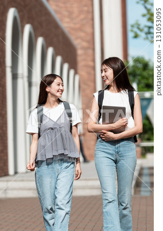 Female college students walking on campus Female college students walking on campus 131053095