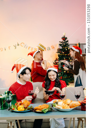 Holiday spirit with Asian friends exchanging gifts, sharing laughs, and enjoying a festive Christmas 131053298