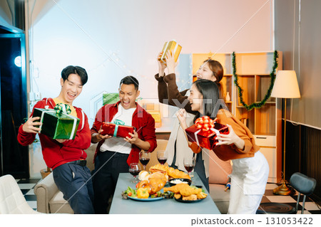 Friends celebrate Christmas with gift exchanges, festive food, and laughtera perfect scene for holiday and New Year Friends celebrate Christmas with gift exchanges, festive food, and laughtera perfect scene for holiday and New Year 131053422