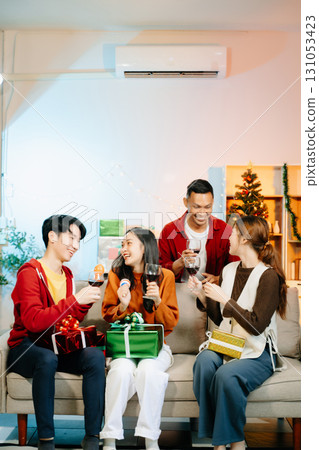 Friends celebrate Christmas with gift exchanges, festive food, and laughtera perfect scene for holiday and New Year Friends celebrate Christmas with gift exchanges, festive food, and laughtera perfect scene for holiday and New Year 131053423