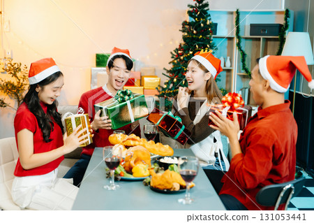 Holiday spirit with Asian friends exchanging gifts, sharing laughs, and enjoying a festive Christmas Holiday spirit with Asian friends exchanging gifts, sharing laughs, and enjoying a festive Christmas 131053441