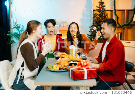 Group of Young Asian friend having, enjoy evening party together at home. Group of Young Asian friend having, enjoy evening party together at home. 131053446