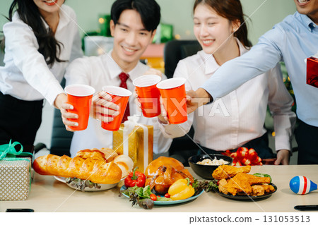 Celebrate Christmas with colleagues in a joyful office party setting, sharing gifts, laughs, and holiday Celebrate Christmas with colleagues in a joyful office party setting, sharing gifts, laughs, and holiday 131053513