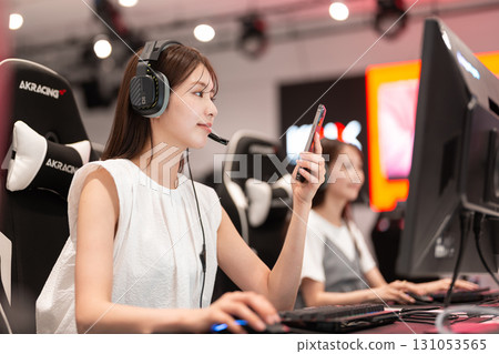 Young woman enjoying games at an e-sports tournament Young woman enjoying games at an e-sports tournament 131053565