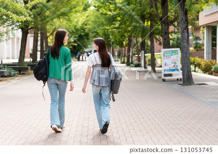 Female college student walking on university campus Female college student walking on university campus 131053745