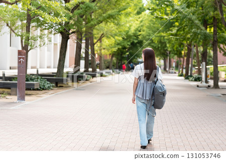 Female college student walking on university campus Female college student walking on university campus 131053746