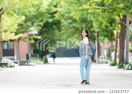Female college student walking on university campus 131053757