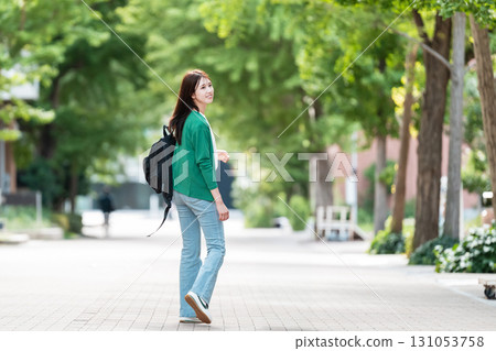 Female college student walking on university campus 131053758
