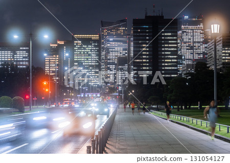 Tokyo: Night view of Tokyo skyscrapers and car light trails Tokyo: Night view of Tokyo skyscrapers and car light trails 131054127