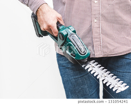 Handsome man, work clothes and hedge trimmer Handsome man, work clothes and hedge trimmer 131054241