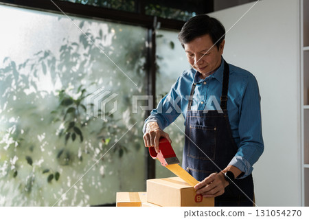 Business professional sealing boxes for e-commerce, highlighting the importance of packaging in online sales. Business professional sealing boxes for e-commerce, highlighting the importance of packaging in online sales. 131054270