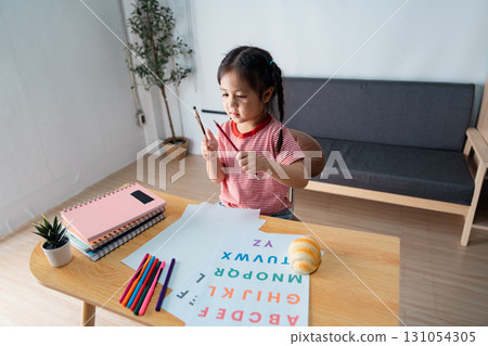 Thoughtful girl pondering while practicing letters at home, exploring creativity and learning 131054305
