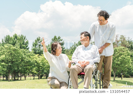 Parents and children walking in the park (caregiving, filial piety) 131054457