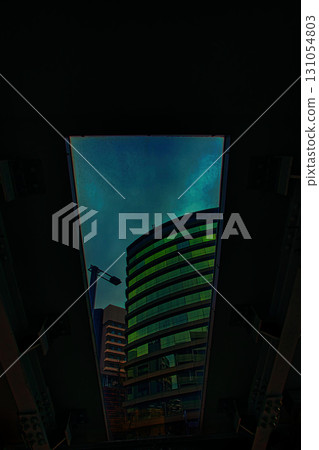 Rainbow-colored gradation visible through the gaps between buildings at night Rainbow-colored gradation visible through the gaps between buildings at night 131054803
