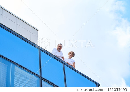 A middle-aged couple standing on the balcony. A middle-aged couple standing on the balcony. 131055493