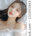 A cute young Japanese woman lying on the bed 131055843