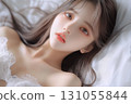 A young woman lying on the bed 131055844