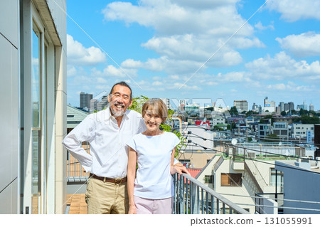 A middle-aged couple standing on the balcony. A middle-aged couple standing on the balcony. 131055991