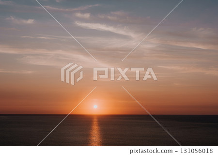 Golden Sunset Over a Calm Sea Golden Sunset Over a Calm Sea 131056018