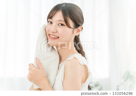 Young Asian woman washing her face and drying it with a towel (face wash) Young Asian woman washing her face and drying it with a towel (face wash) 131056296