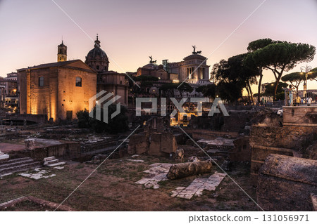 Roman Forum ruins with illuminated historical buildings and monuments at dusk in Rome, Italy 131056971