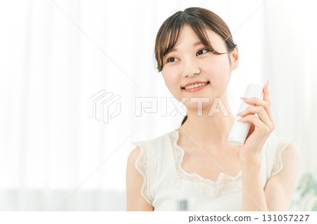 Young Asian woman holding beauty serum, skin care product Young Asian woman holding beauty serum, skin care product 131057227