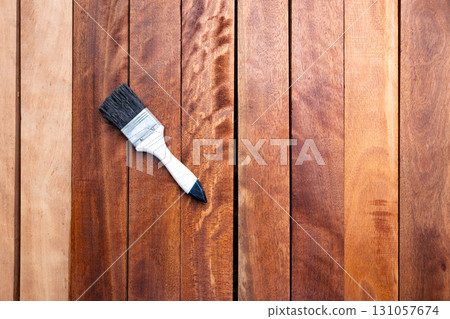 Paint brush and wood material in construction work. 131057674