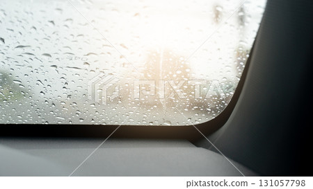 Rain drops on the car window. Rain drops on the glass. Drving in the rainy time. The silence and the long rain on the road. Rain drops on the car window. Rain drops on the glass. Drving in the rainy time. The silence and the long rain on the road. 131057798