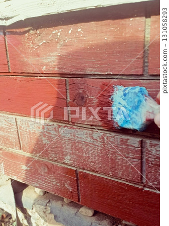 Wood Plank Repainting in Documentary Style in Warm Reds representing Outdoor Maintenance Wood Plank Repainting in Documentary Style in Warm Reds representing Outdoor Maintenance 131058293