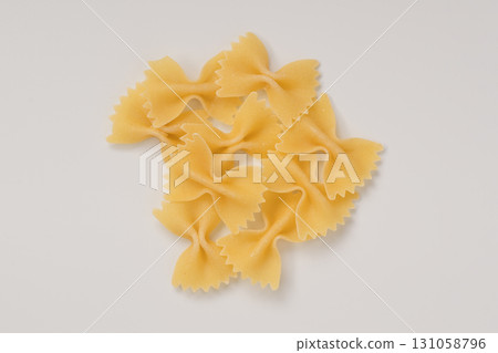Dry farfalle pasta on white background top view 131058796