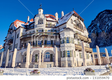 Majestic Alpine Palace Blends Jugendstil and Baroque Elements in Stunning Mountain Setting Ornate White Facade with Intricate Details Showcases Austrian Architectural Grandeur Against Picturesque Majestic Alpine Palace Blends Jugendstil and Baroque Elements in Stunning Mountain Setting Ornate White Facade with Intricate Details Showcases Austrian Architectural Grandeur Against Picturesque 131059470