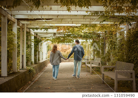 Young Cute Female Hugs Boyfriend. In Autumn Outdoor. Lovers Walking in Park. Attractive Funny Couple. Lovestory in Forest. Man and Woman. Cute Lovers in the Park. Family Concept. Happy Couple. 131059490