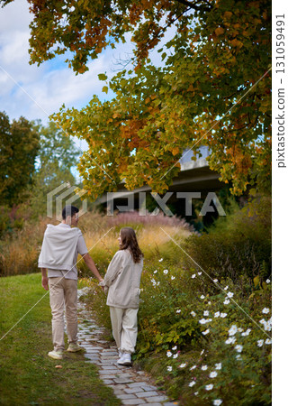 Young Cute Female Hugs Boyfriend. In Autumn Outdoor. Lovers Walking in Park. Attractive Funny Couple. Lovestory in Forest. Man and Woman. Cute Lovers in the Park. Family Concept. Happy Couple. 131059491