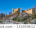 Hohenschwangau, Yellow castle near Neuschwanstein Castle on a hill, magical palace with tall spires on top of the mountain, gothic architecture in the background 131059612