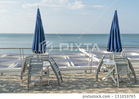 Relaxing Seaside View With Umbrellas and Tables on a Sunny Day 131059765