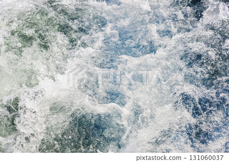 water churned up by propeller behind boat's stern 131060037