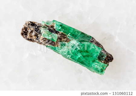 sample of raw emerald crystal on white marble 131060112