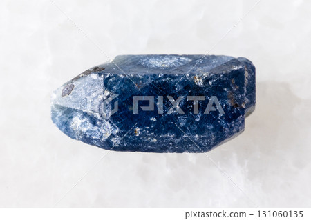 rough single blue sapphire crystal on white 131060135