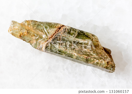 sample of rough epidote crystal on white marble sample of rough epidote crystal on white marble 131060157