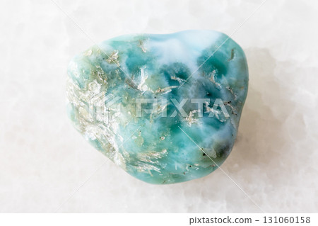 sample of rough larimar mineral on white marble 131060158