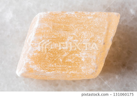 sample of raw selenite mineral on white marble 131060175