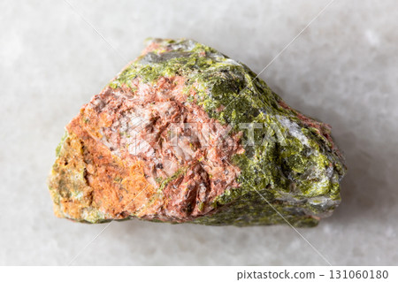 sample of raw unakite rock on white marble 131060180