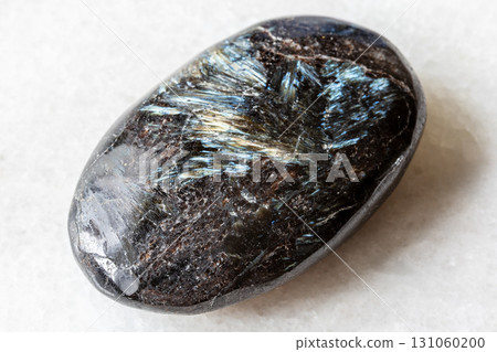 sample of polished nuummite gemstone on white 131060200