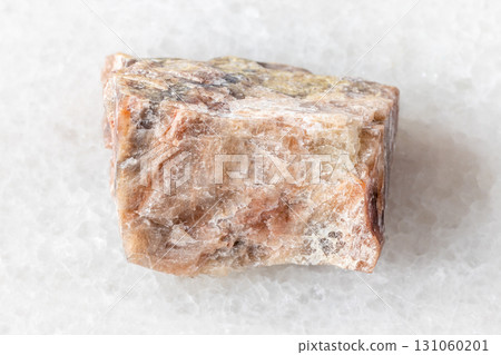 sample of raw nepheline mineral on white marble 131060201